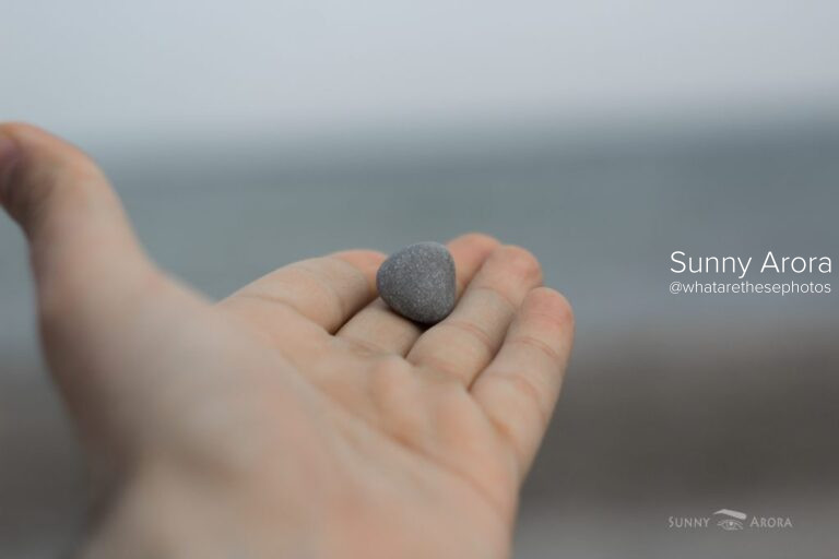 close up of hand with a stone on its fingers