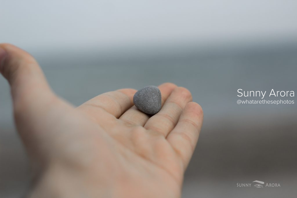 close up of hand with a stone on its fingers